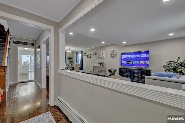 living room with a chandelier, ornamental molding, and dark wood-type flooring