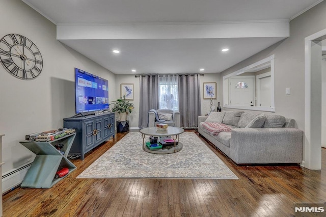 living room with dark wood-type flooring and ornamental molding