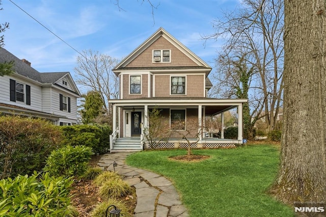 view of front facade featuring covered porch and a front lawn