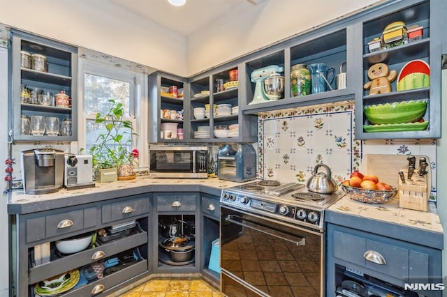 kitchen with blue cabinetry and range with electric cooktop