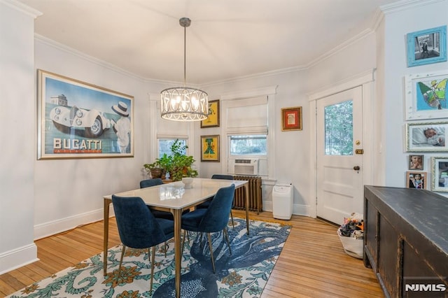 dining space with crown molding, light hardwood / wood-style flooring, cooling unit, and an inviting chandelier