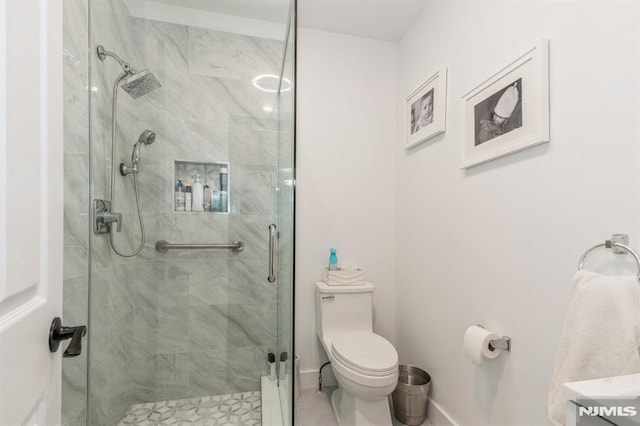 bathroom featuring an enclosed shower and toilet