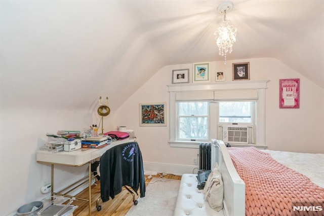 bedroom with light hardwood / wood-style floors, cooling unit, and lofted ceiling