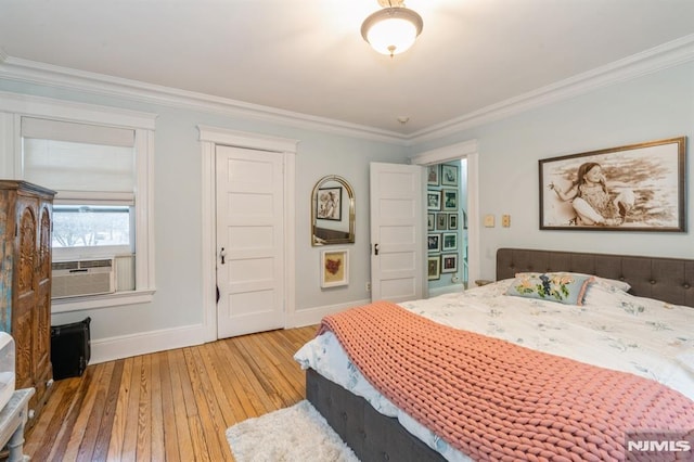 bedroom with cooling unit, wood-type flooring, and ornamental molding