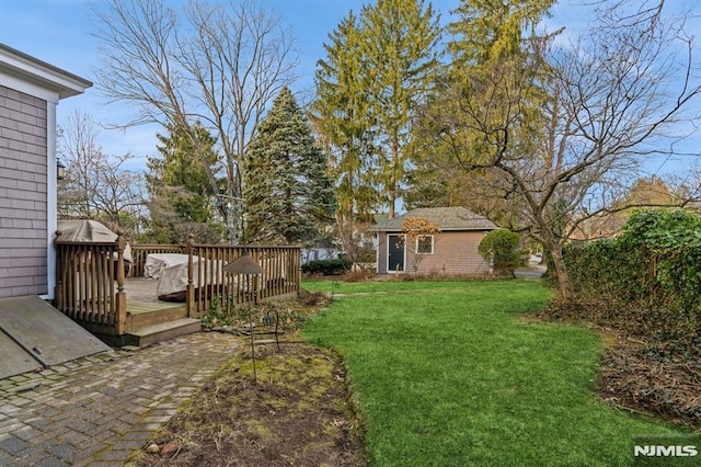 view of yard with an outbuilding and a deck