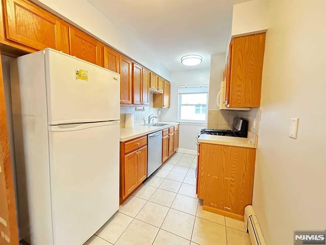 kitchen with white appliances, light countertops, a sink, and light tile patterned flooring