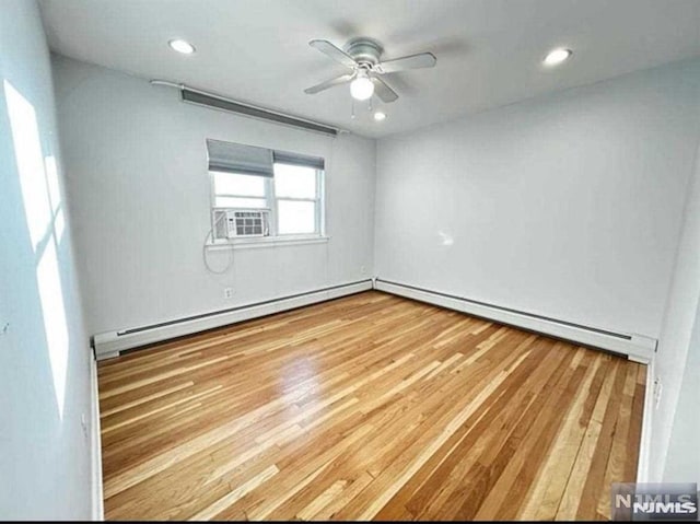 unfurnished room with cooling unit, recessed lighting, a baseboard radiator, ceiling fan, and light wood-type flooring