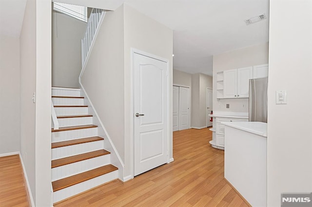 stairs featuring hardwood / wood-style flooring