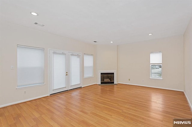 unfurnished living room with light hardwood / wood-style floors