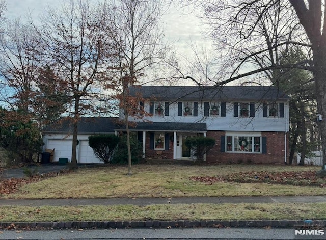 view of front of property with a garage and a front yard