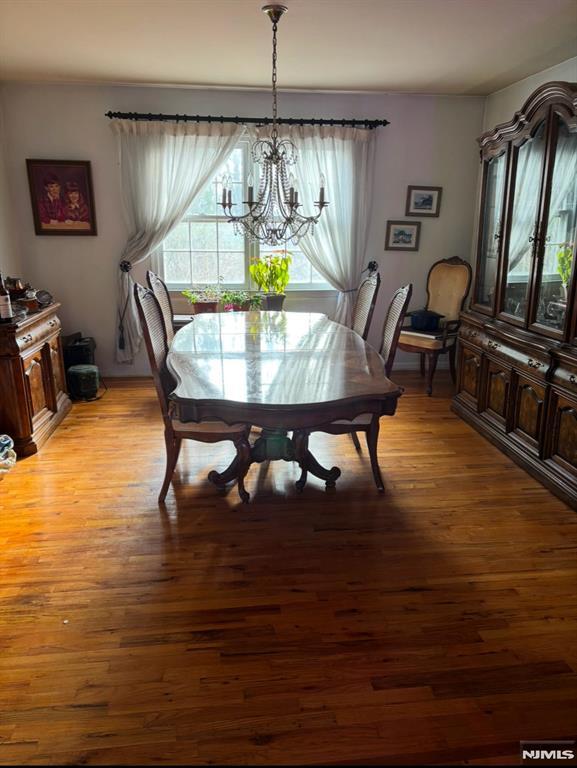 dining space with a notable chandelier and light wood-type flooring