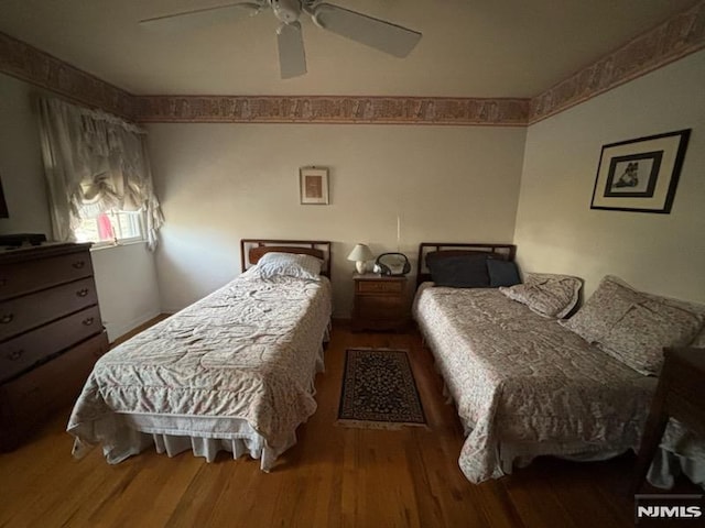 bedroom with wood-type flooring and ceiling fan