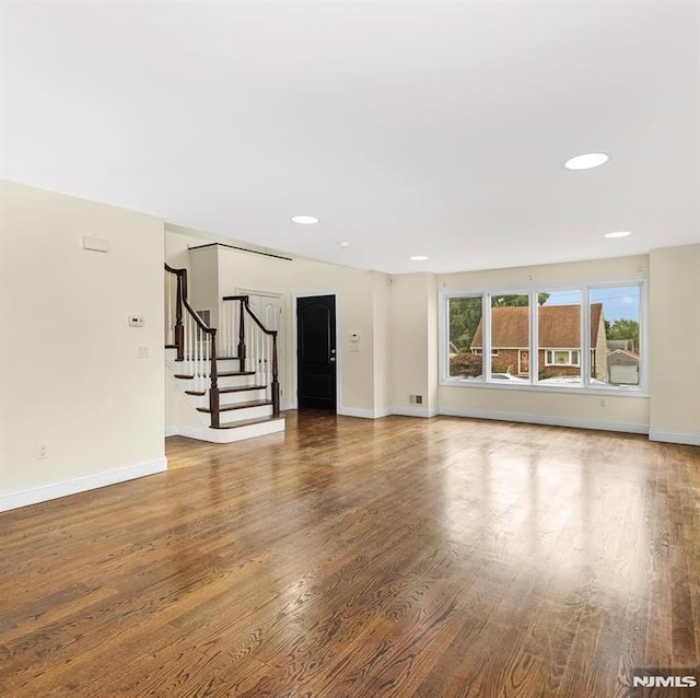 unfurnished living room with wood-type flooring