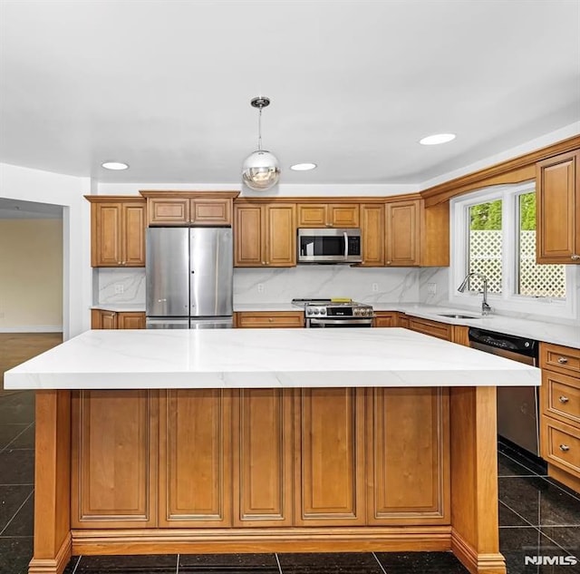 kitchen featuring appliances with stainless steel finishes, a center island, and tasteful backsplash