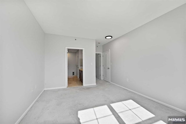 unfurnished bedroom featuring light colored carpet