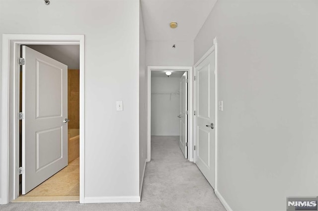 hallway featuring light carpet