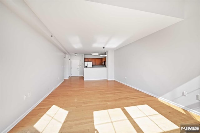 unfurnished living room with light wood-type flooring