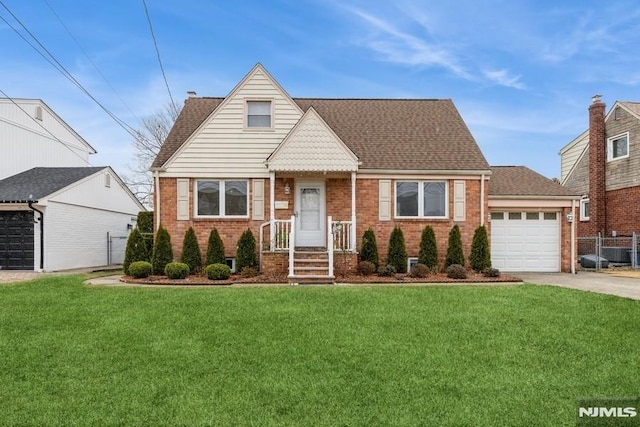 view of front of property featuring a front yard and a garage