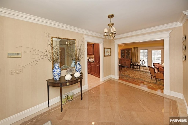 hall featuring a notable chandelier and ornamental molding