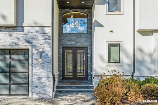 view of exterior entry featuring french doors