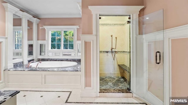 bathroom featuring ornamental molding and independent shower and bath