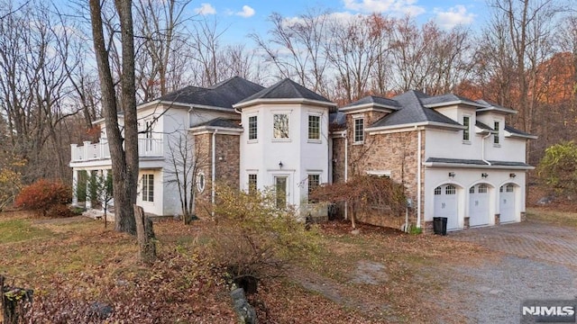 view of front of property with a garage and a balcony