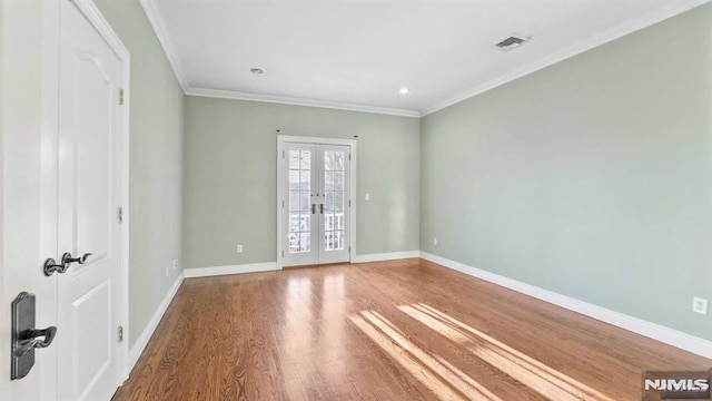 spare room featuring crown molding, french doors, and wood-type flooring