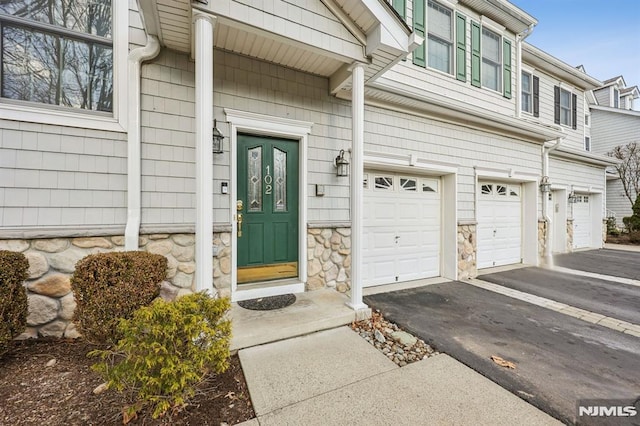 doorway to property with a garage