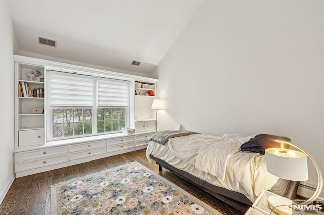 bedroom featuring vaulted ceiling and dark hardwood / wood-style floors