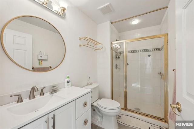 bathroom with vanity, walk in shower, and toilet