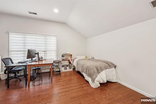 bedroom featuring lofted ceiling and dark hardwood / wood-style floors