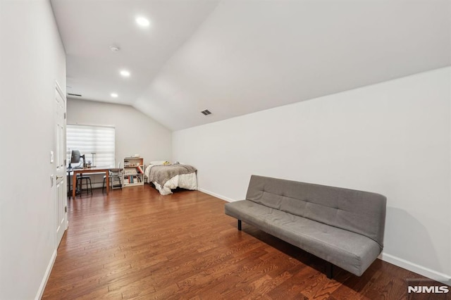 bedroom featuring dark wood-type flooring and vaulted ceiling