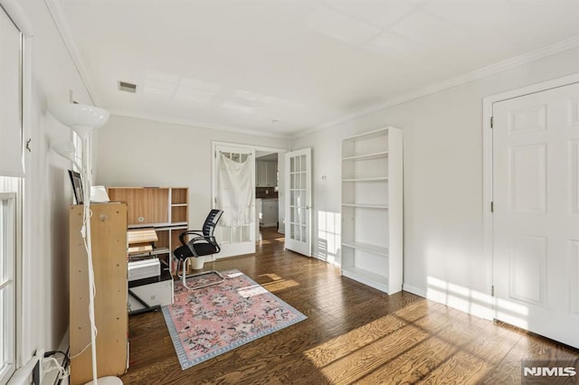 office featuring built in shelves, dark wood-type flooring, french doors, and ornamental molding