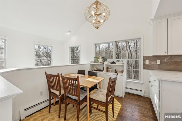 dining space featuring baseboard heating, a chandelier, and a healthy amount of sunlight