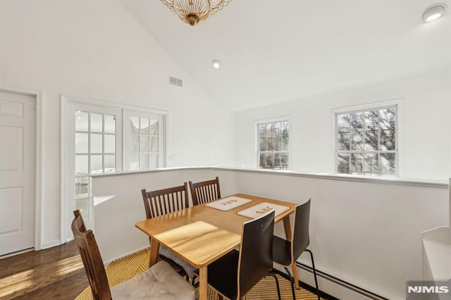 dining room with high vaulted ceiling, a baseboard heating unit, and dark hardwood / wood-style floors