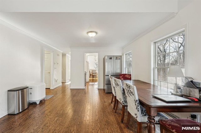 dining room with crown molding and dark hardwood / wood-style floors