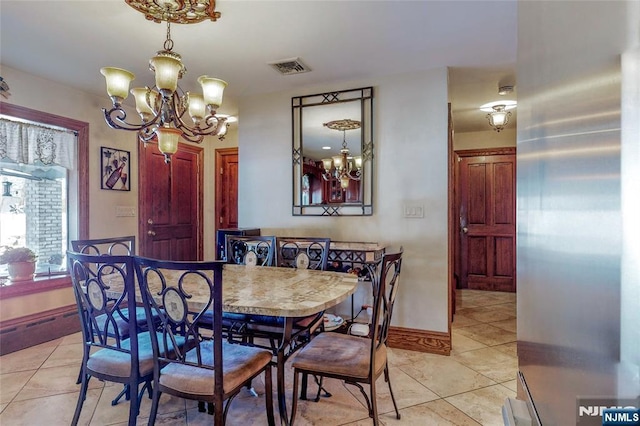 tiled dining space featuring a notable chandelier