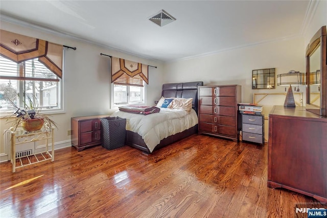 bedroom featuring crown molding and dark hardwood / wood-style flooring