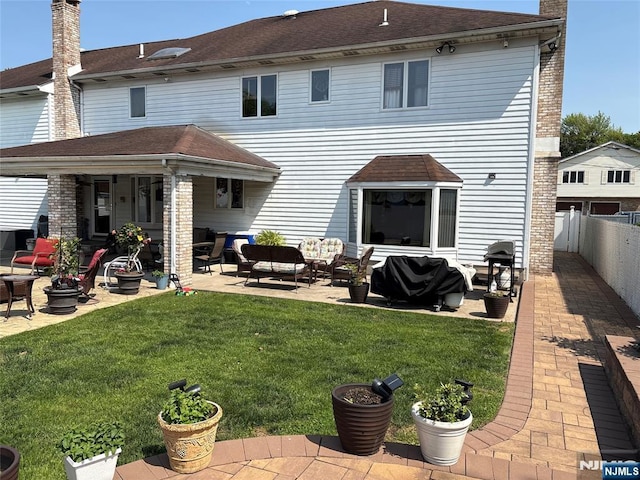 20 Albert St, Moonachie, NJ 07074 - back of property featuring an outdoor hangout area, a patio area, and a chimney
