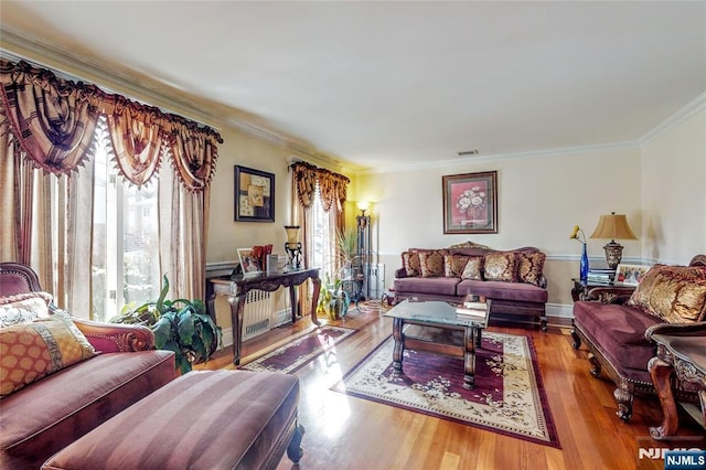 living room featuring crown molding and light wood-type flooring