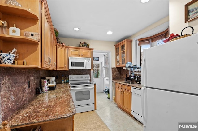 kitchen with white appliances, tasteful backsplash, and sink