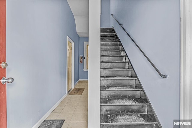 staircase with tile patterned floors