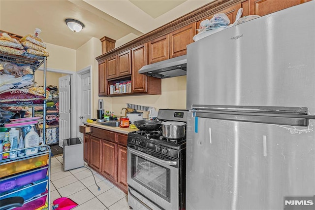 kitchen with sink, light tile patterned floors, and stainless steel appliances