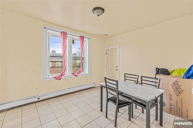 tiled dining area featuring baseboard heating