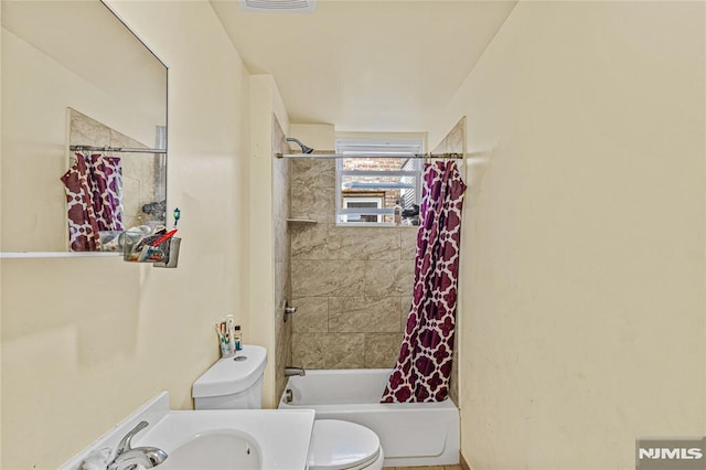 full bathroom featuring vanity, shower / tub combo, and toilet