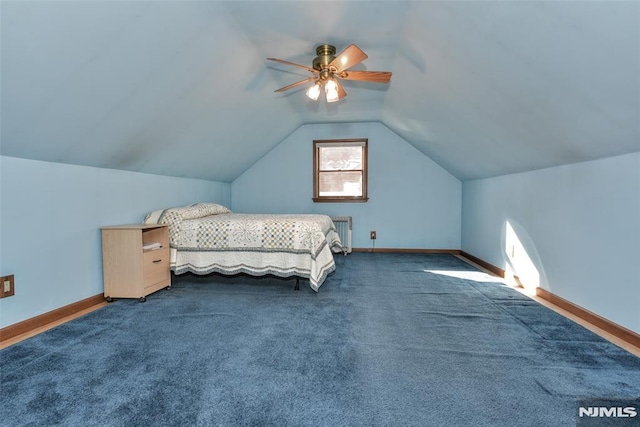 carpeted bedroom with ceiling fan, radiator heating unit, and vaulted ceiling