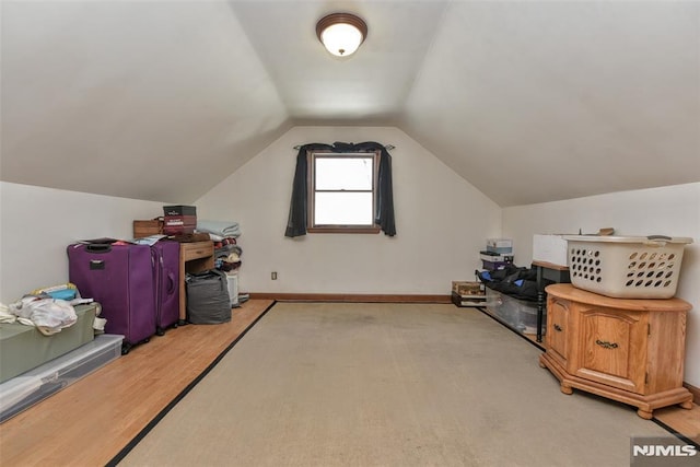 bonus room featuring light hardwood / wood-style flooring and lofted ceiling