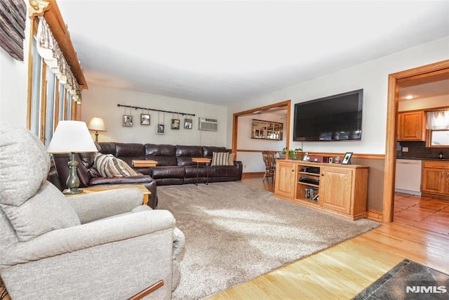 living room with hardwood / wood-style flooring and a wall mounted air conditioner