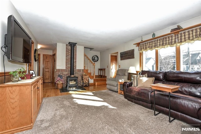 carpeted living room with a wood stove