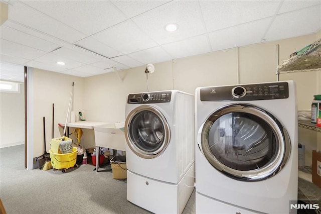 laundry area featuring washer and dryer and carpet